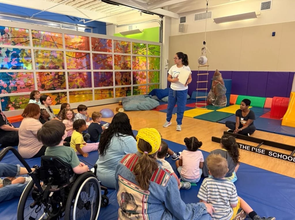 A teacher leads students and families in the Rise School of Houston gym