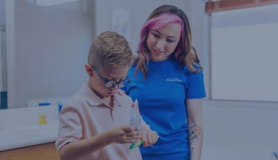 Hopebridge clinician supporting a child during an autism therapy activity