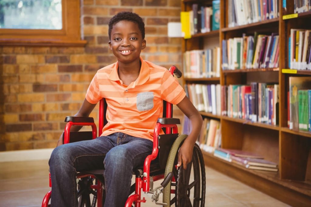 Student using a wheelchair in a library
