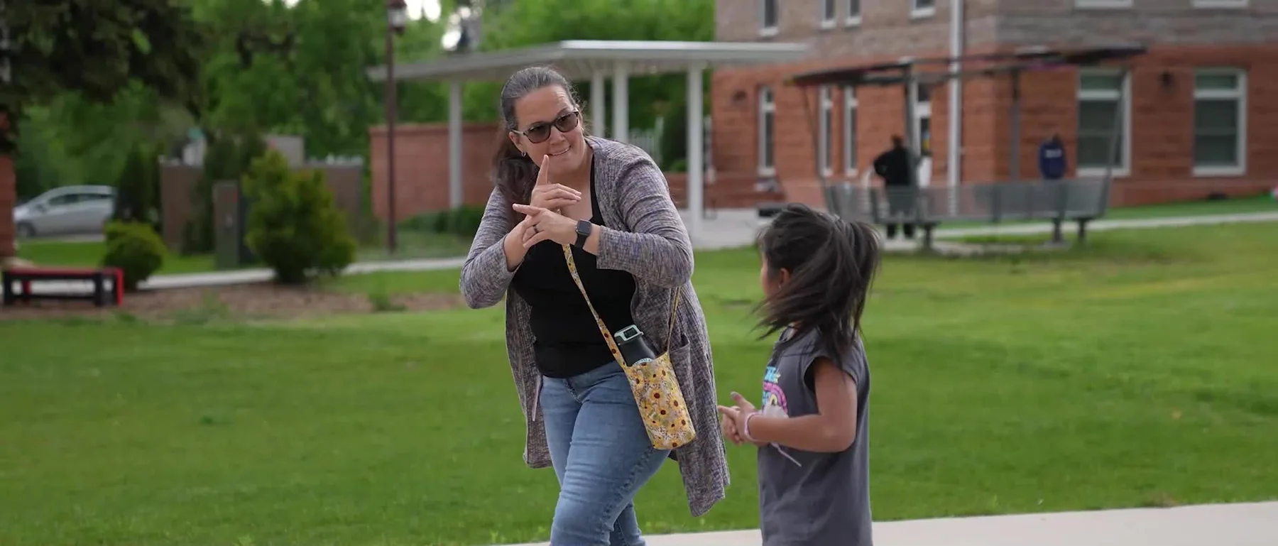 Colorado School for the Deaf and the Blind student walking across the Colorado Springs campus.