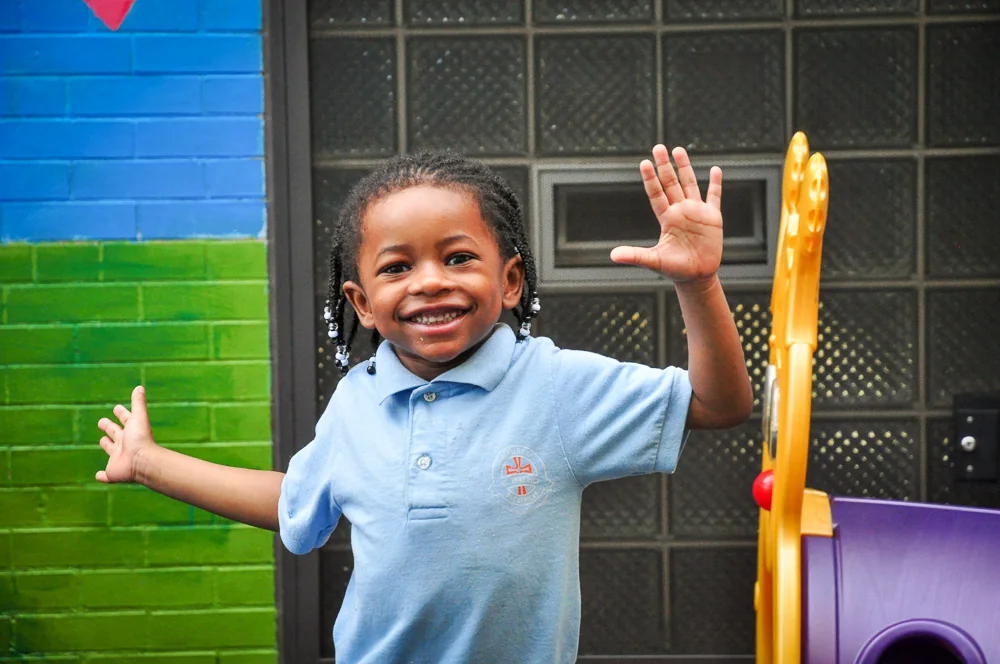 A student playing outside the school at Academy of St Benedict