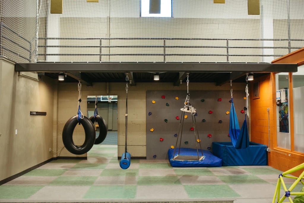 Swings and climbing equipment inside Woven Care Central East