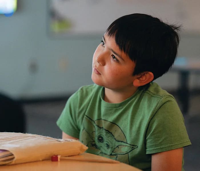 A New Way Academy student listens during a classroom lesson
