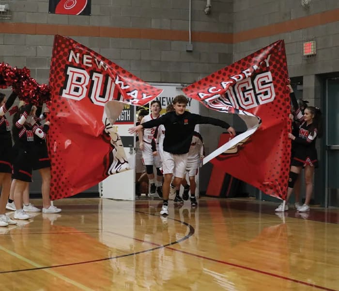New Way Academy students enter a school basketball game