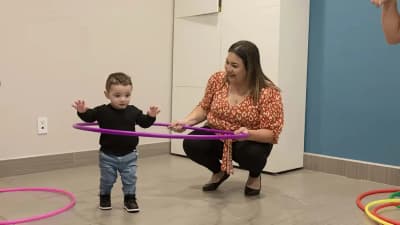 Child and therapist participating in a supported movement activity at ACES ABA.