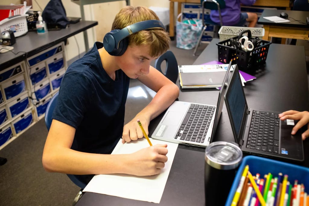 The Piedmont School student working with a laptop in a classroom