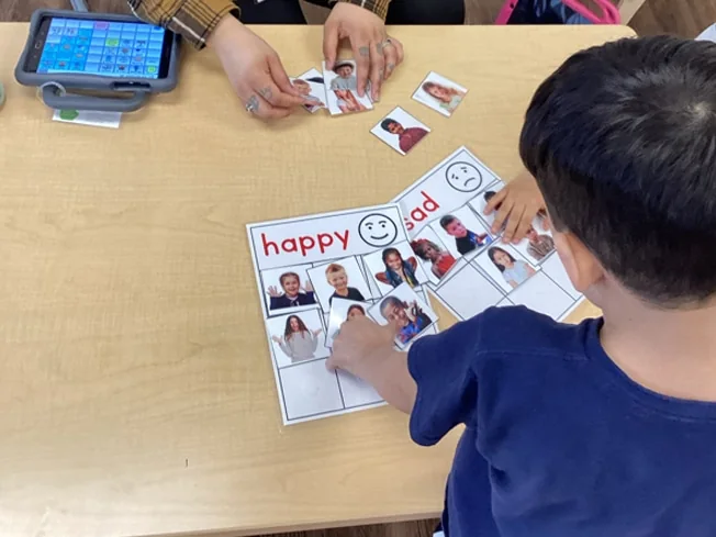 A student completing a classroom activity at Merlin Day Academy