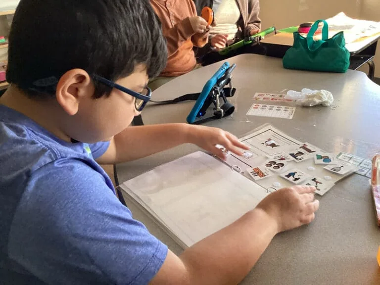 A student working with learning materials at Merlin Day Academy