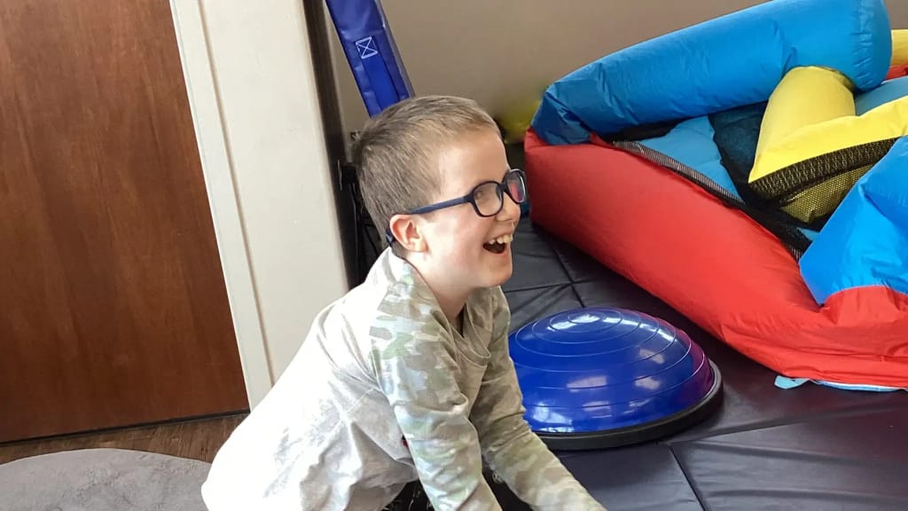 A student enjoying a sensory activity at Merlin Day Academy