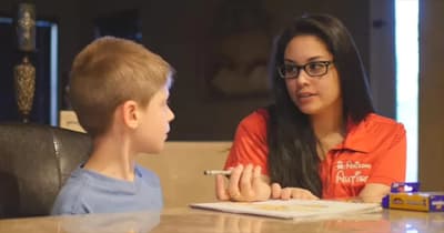 Arizona Autism therapist working with a child during a tabletop activity.