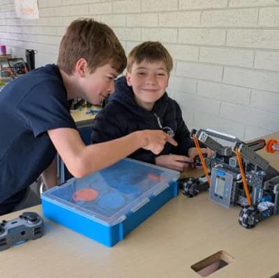 Old Mission School students working together on a robotics project.