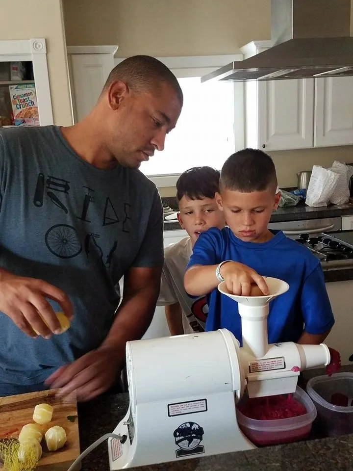 Adult supporting children during a cooking activity