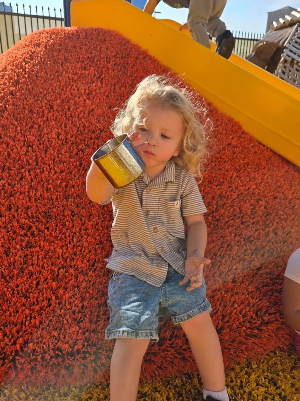 Rise School of San Antonio student exploring an outdoor sensory surface