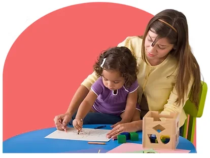 Adult supporting a child during a hands-on activity