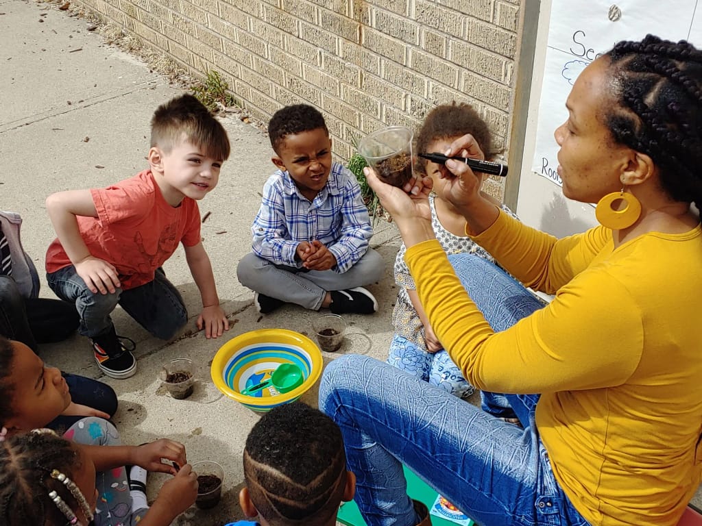 Teacher leading an outdoor activity with Hope Center students