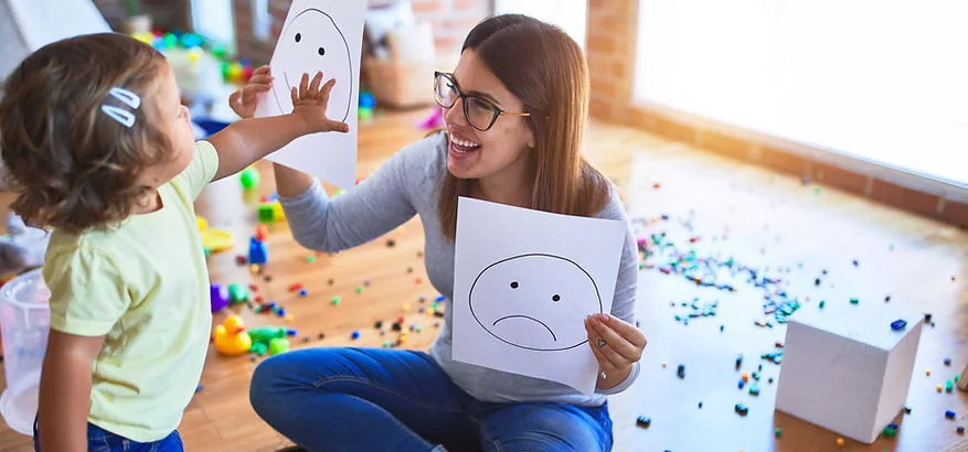 Adult using a visual emotion card with a young child