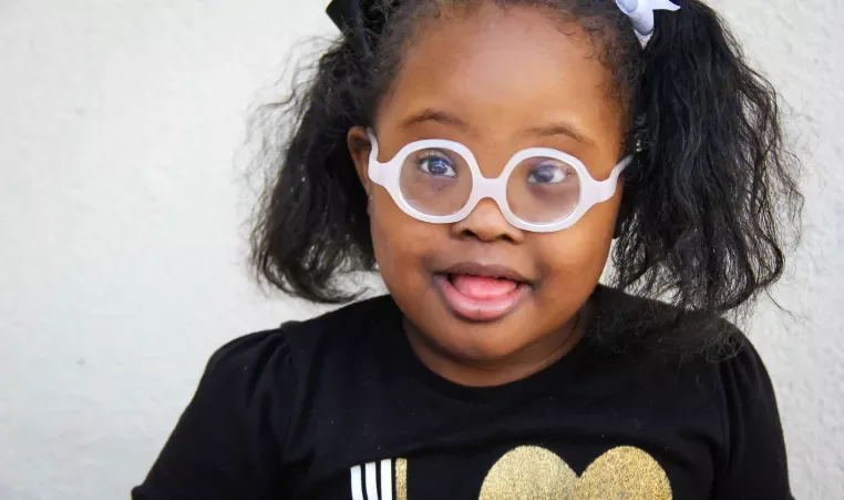 A Rise School of Dallas student smiles for a school portrait