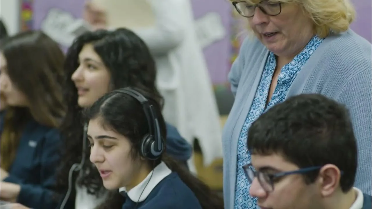 AGBU Manoogian teacher helping students during a computer lesson