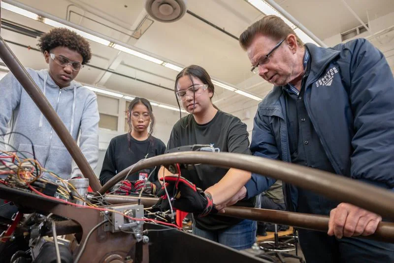 Juarez Academy of Engineering & Technology in Cerritos, CA: students and staff working on a robotics project.