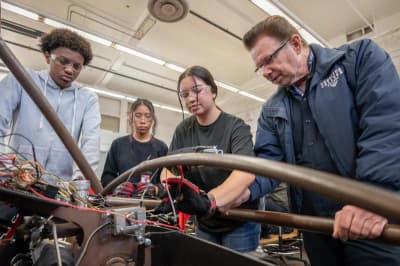 Juarez Academy of Engineering & Technology in Cerritos, CA: students and staff working on a robotics project.