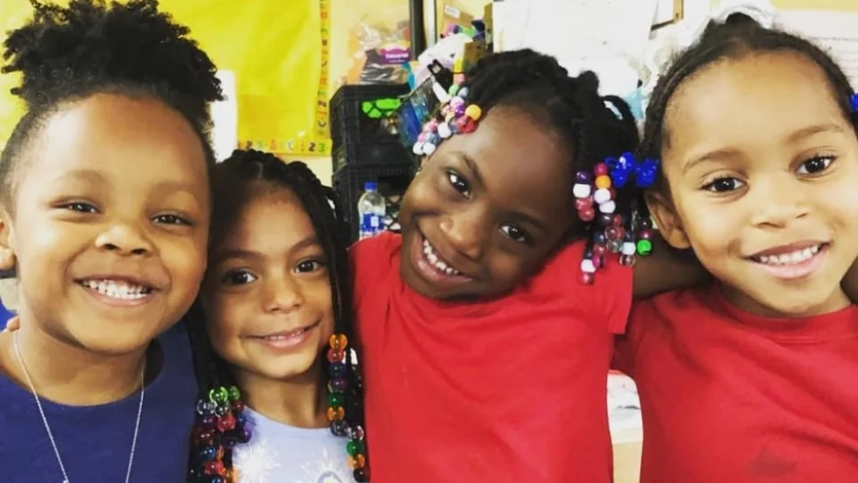 Classmates smiling together at school at Little Scholars Academy