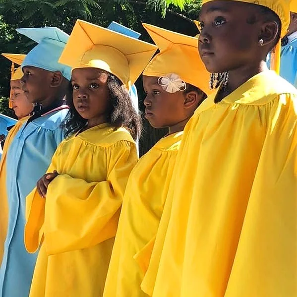 Young students celebrating graduation at Little Scholars Academy