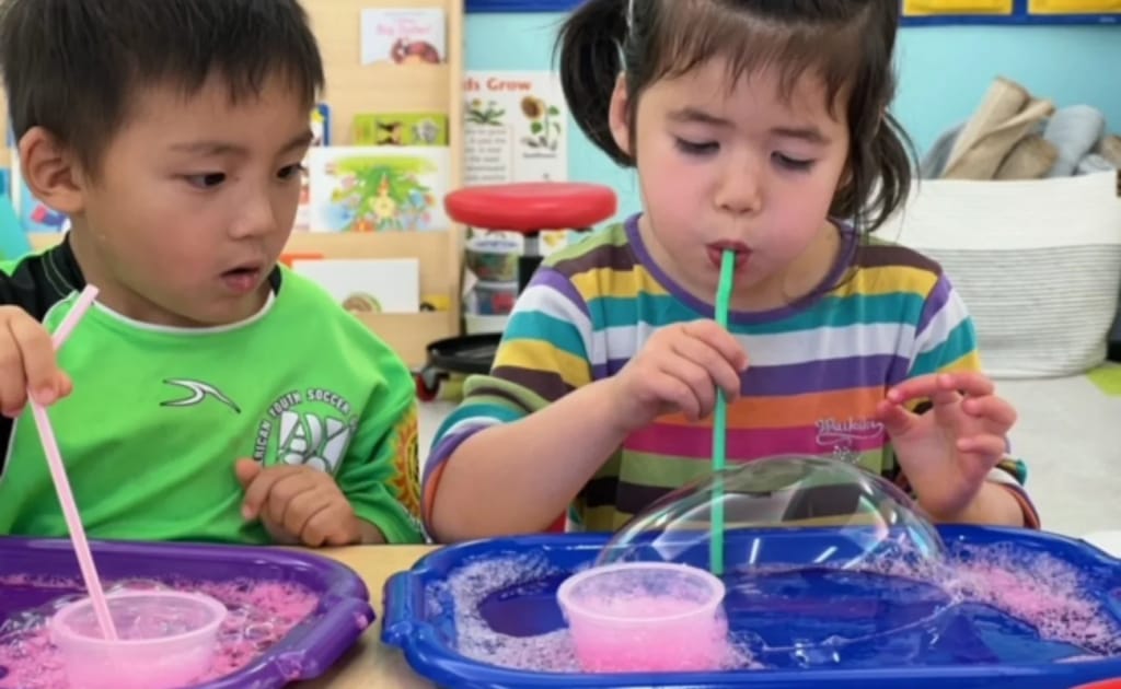 Faith Hope and Love Chinese School children doing a bubble activity