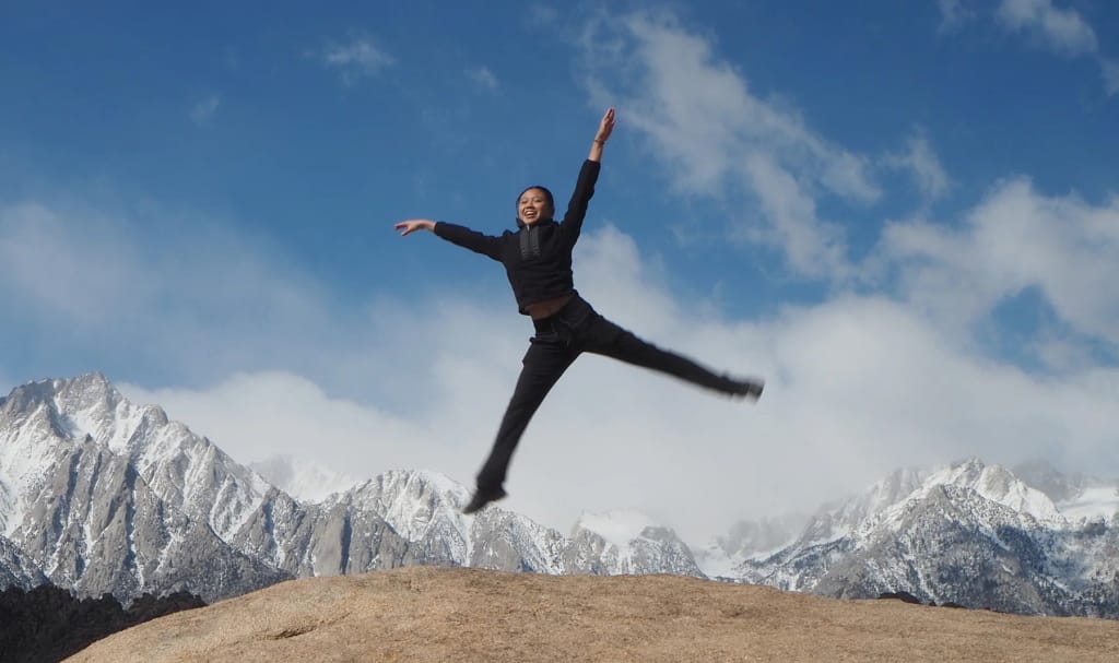 Odyssey School student jumping during a mountain expedition