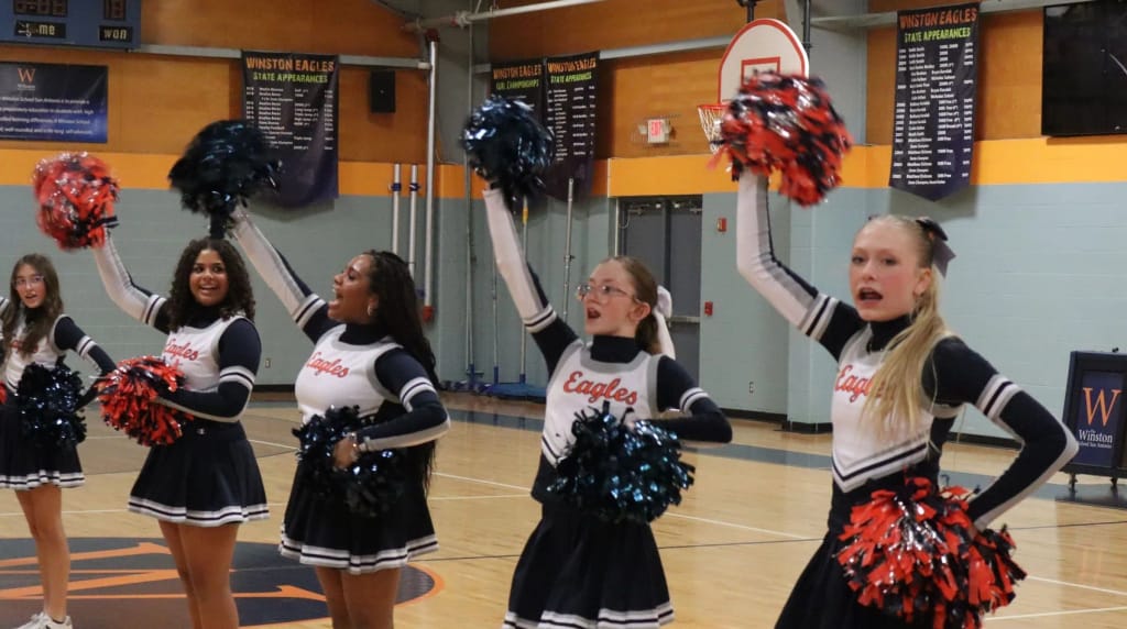 Winston School San Antonio cheerleaders performing in the gym