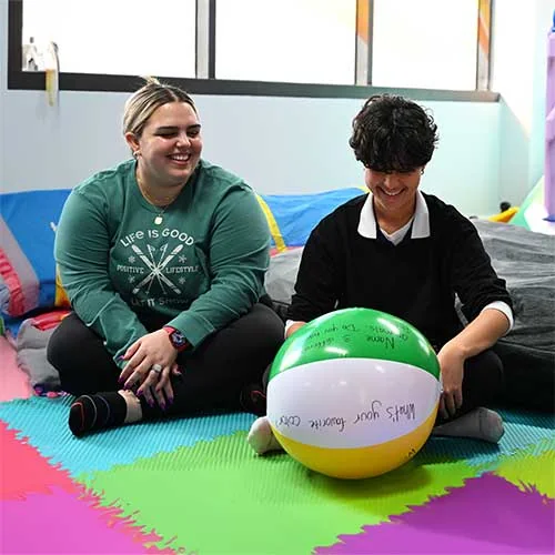 Teen participating in an indoor therapeutic activity at Texas ABA Centers.