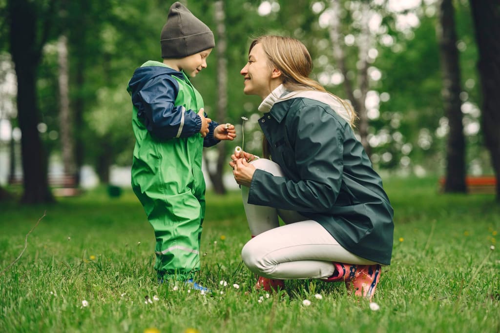 Caregiver and child playing outdoors