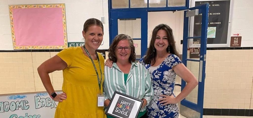 Harold H. Galligan School staff and student celebrate a school achievement.