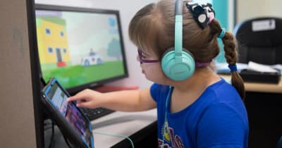 Child using an educational computer activity at May Institute.