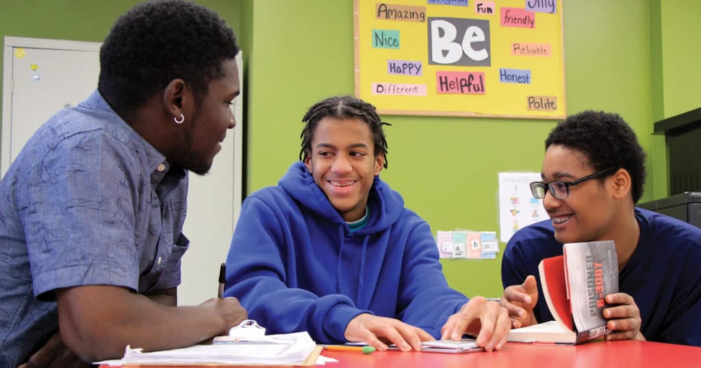 Students and an instructor working together during a group learning activity at May Institute.