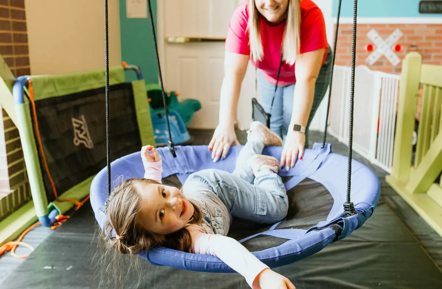 Child participating in an indoor sensory activity at Sunshine Autism Center.