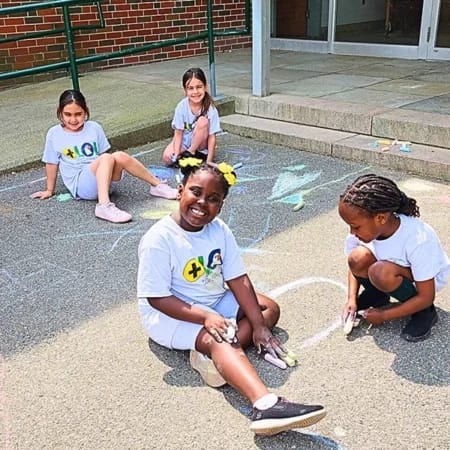 Our Lady of Lourdes School students play outside on the school grounds.