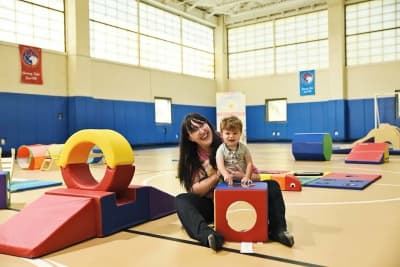 Happy Day Play instructor and child using play equipment at Bernikow JCC