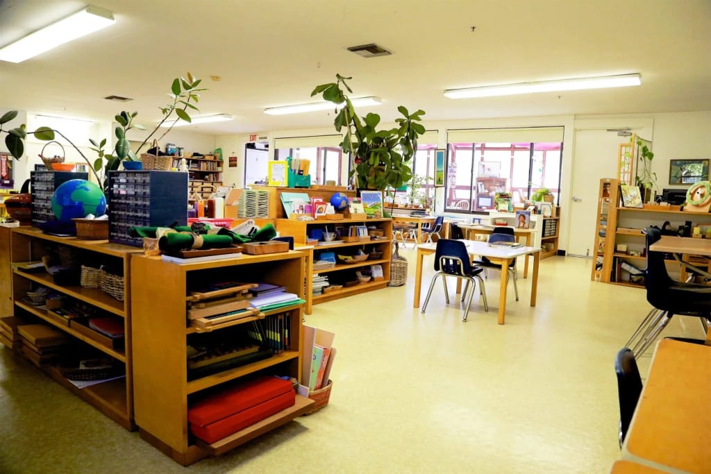 Montessori Children's School classroom prepared with shelves and hands-on learning materials.
