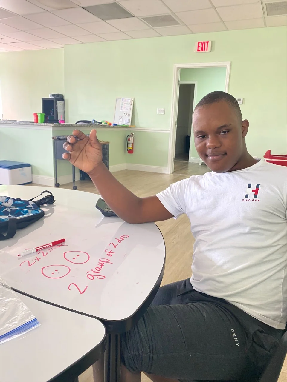 Participant working at a table during an indoor activity shared by Mindful Masterpieces.
