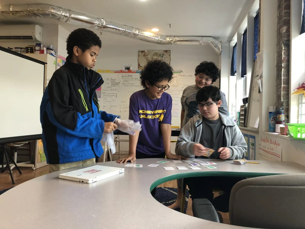 Allied Achievement students collaborating around a classroom table