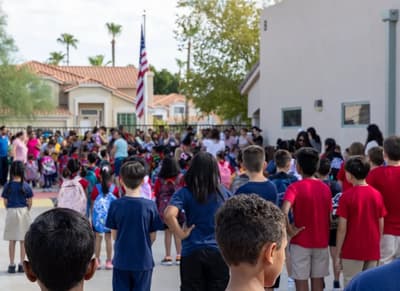 Milestones Charter School students gathered around the flag for the morning pledge