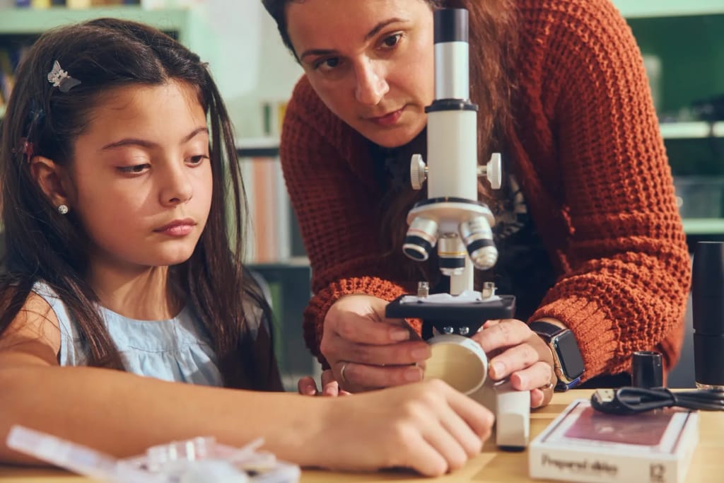 Primer Microschools student working with a microscope
