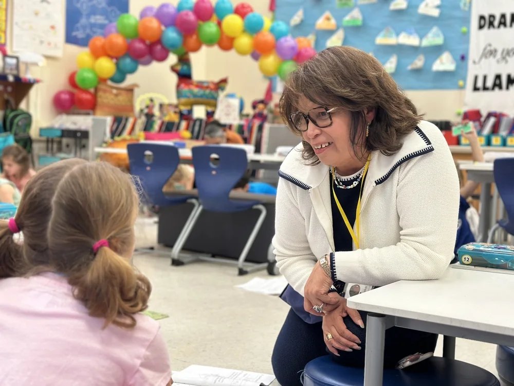 Woodridge Elementary teacher speaking with a student
