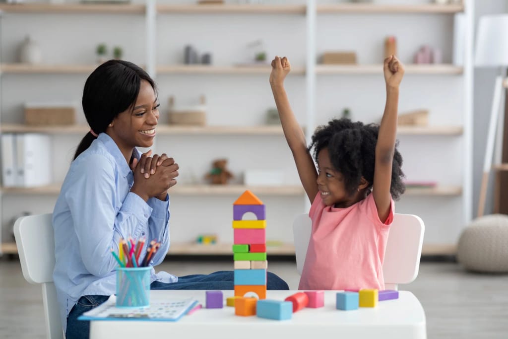 Adult and child playing with colorful building blocks