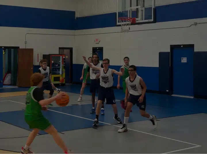 Students playing basketball in the school gym at Cumberland Academy of Georgia