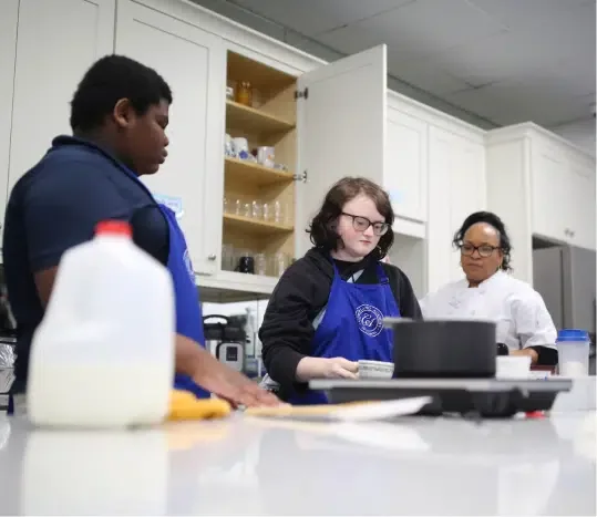 Students learning practical skills in class at Cumberland Academy of Georgia