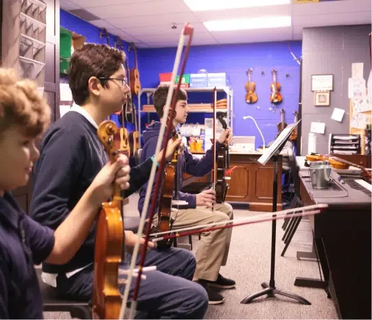 Students rehearsing in the music room at Cumberland Academy of Georgia