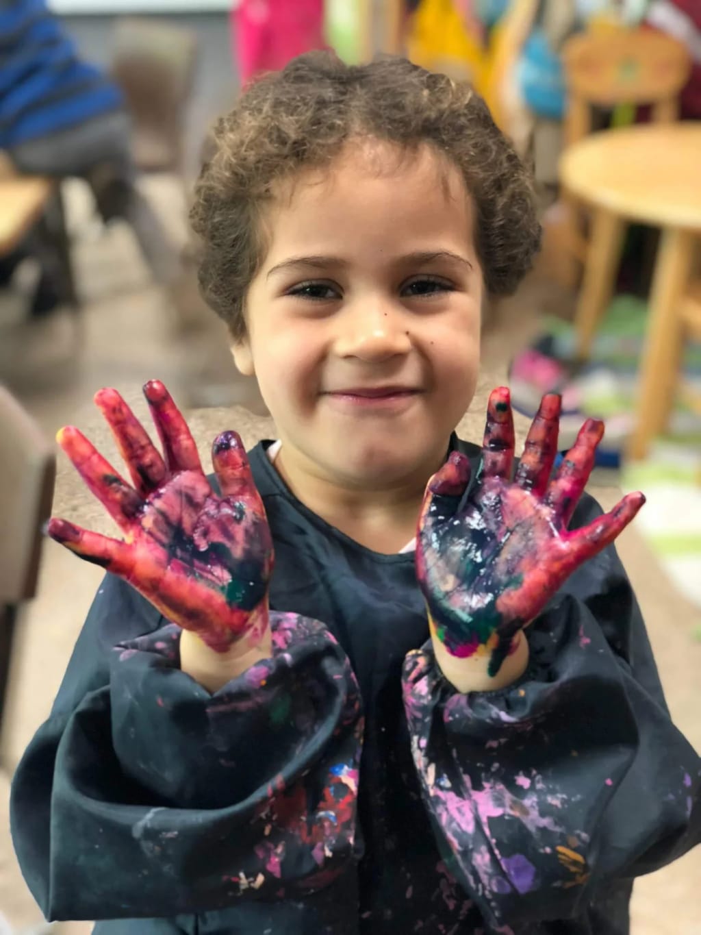 Cedar Lane Nursery School in Bethesda: child displaying a classroom art activity.