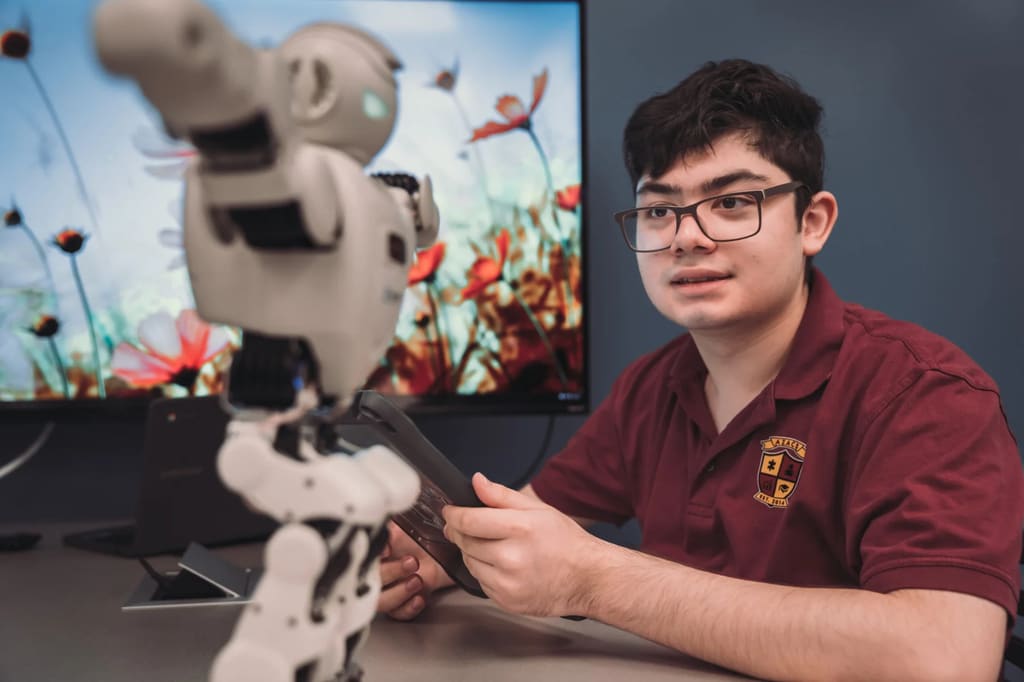An Arizona Autism Charter School student works with a classroom robot