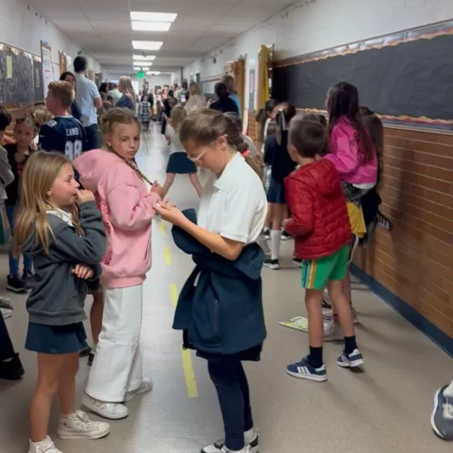J.E. Cosgriff Memorial Catholic School students working together in a school hallway.